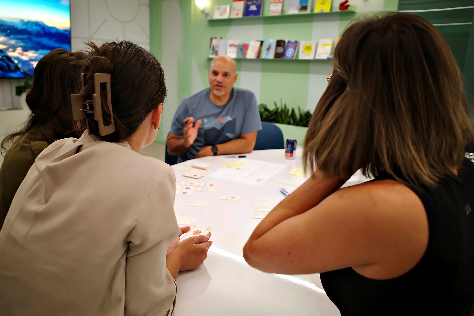 Players around a table, mid-discussion, cards spread out