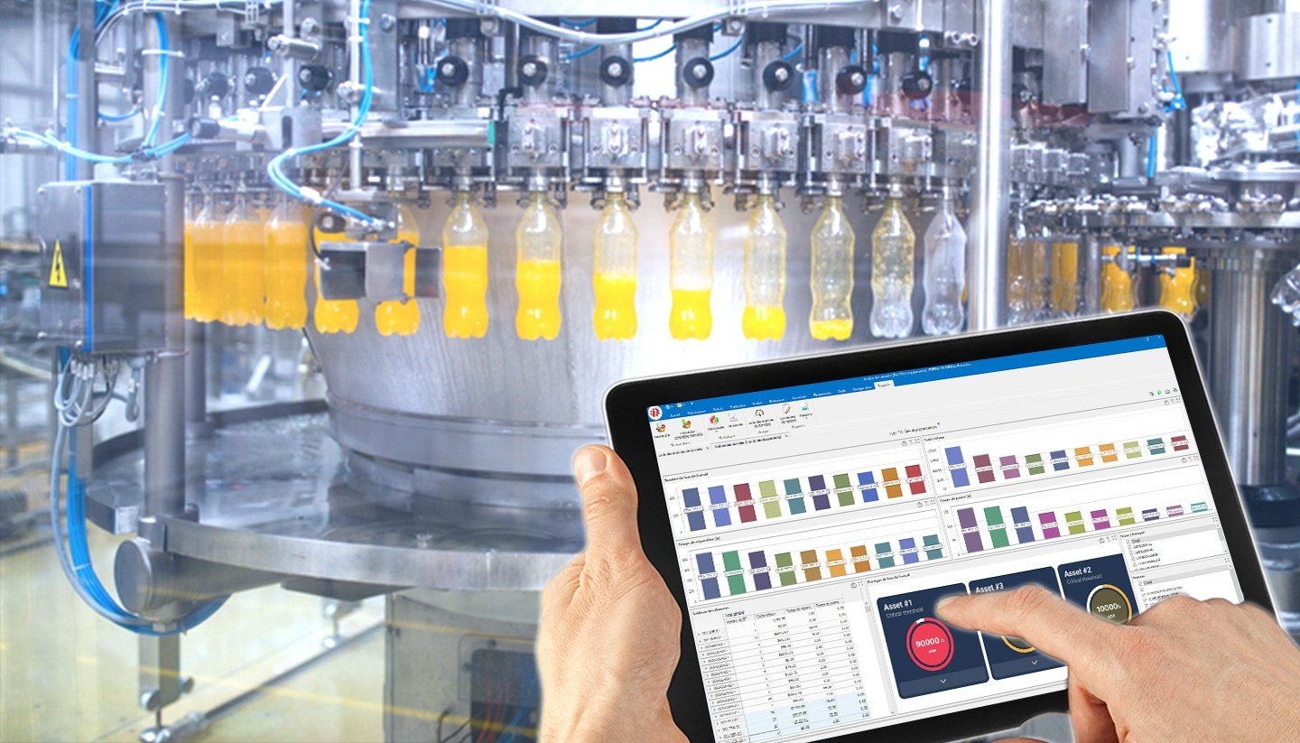 Hands holding a tablet beside a bottling line, showing the maintenance dashboard prototype